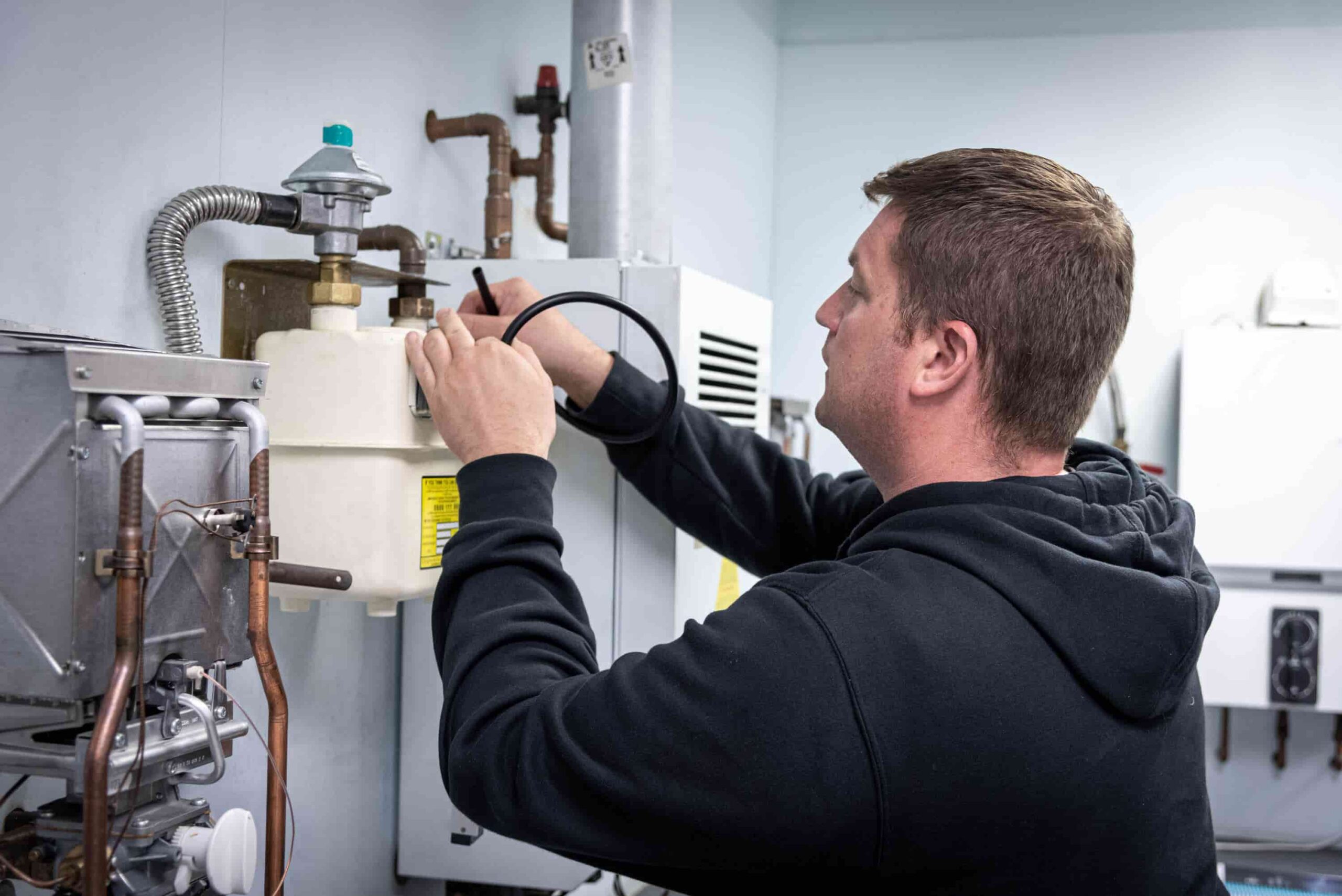 man working on a gas meter in a training centre